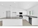 Contemporary kitchen featuring granite countertops, stainless steel appliances, and white cabinets at 1792 Aurora Oak Ln, Sanford, FL 32771