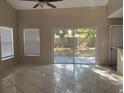 Bright living room features tile floors, neutral paint and sliding glass doors to a patio at 2708 Smithfield Dr, Orlando, FL 32837