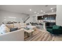 Open living room with L-shaped sofa, and kitchen island at 7420 Oakmoss Loop, Davenport, FL 33837