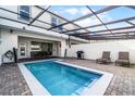 Private pool with patio furniture, grill, and covered lanai at 7420 Oakmoss Loop, Davenport, FL 33837