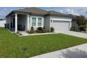 Inviting one-story home features a manicured lawn and lovely curb appeal at 881 Orchid Grove Blvd, Davenport, FL 33837