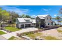Beautiful waterfront home with a modern design, lush landscaping, and a private dock at 1340 Susannah Blvd, Orlando, FL 32803