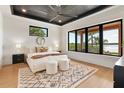 Modern main bedroom with a large window, tray ceiling, neutral colors, and an elegant area rug at 1340 Susannah Blvd, Orlando, FL 32803