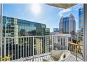 Balcony view with white railings and modern city architecture at 155 S Court Ave # 1602, Orlando, FL 32801