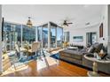 Sun-drenched living room with floor-to-ceiling windows and city views, seamlessly blends dining and relaxation at 155 S Court Ave # 1602, Orlando, FL 32801
