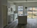 Modern kitchen featuring white shaker cabinets, quartz countertops, and an island at 4655 Sw 139Th Ln, Ocala, FL 34473