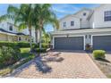 Charming townhome features a two-car garage, brick paver driveway, and mature landscaping at 762 Terrace Spring Dr, Orlando, FL 32828