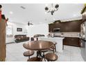 Open-concept kitchen and living area featuring dark cabinetry, a large island, and modern appliances at 2097 Celebration Blvd, Celebration, FL 34747
