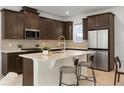 Gourmet kitchen with stainless steel appliances, stone countertops, and a breakfast bar at 2097 Celebration Blvd, Celebration, FL 34747