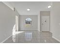 Open living area with tile floors and an arched window at 2102 Kingswood Ave, Deltona, FL 32725