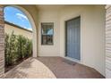Inviting covered porch with stone accents and a stylish blue front door at 541 Cantabria Dr, Davenport, FL 33837