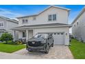 Two-story home with well-kept lawn, brick driveway, and a black Escalade parked in front at 159 Golden Noble St, Kissimmee, FL 34747