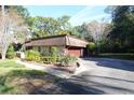 Stone facade home featuring a well-maintained yard and driveway at 306 Wild Olive Ln, Longwood, FL 32779