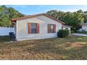 Side view of the house showcasing its light beige siding at 1748 Haverhill Dr, Deltona, FL 32725