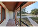 A view of a well-maintained screened porch with tiled floors at 1748 Haverhill Dr, Deltona, FL 32725