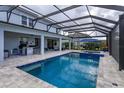 Inviting pool area with a covered patio and outdoor kitchen at 4150 Sunset Preserve Blvd, Orlando, FL 32820