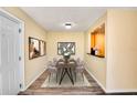 Cozy dining area featuring a modern table with six chairs and contemporary artwork on the walls at 2053 Dixie Belle Dr # 2053C, Orlando, FL 32812