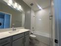 Well-lit bathroom featuring a vanity, sink, and tiled shower/tub combination at 5298 Teirgarten St, St Cloud, FL 34771