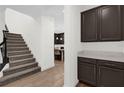 Hallway featuring a stairway, cabinets, and entry into a kitchen at 13007 Bromborough Dr, Orlando, FL 32832