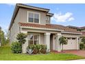 Charming home exterior featuring a well-manicured lawn and two-car garage at 13007 Bromborough Dr, Orlando, FL 32832
