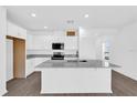 Open kitchen featuring white cabinetry, granite counters and stainless appliances at 410 Sequoia Dr, Lake Wales, FL 33859