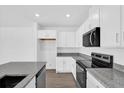 Bright kitchen featuring white cabinets and stainless steel appliances at 410 Sequoia Dr, Lake Wales, FL 33859