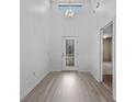 Bright foyer with light wood floors, a decorative chandelier, and a glass-paneled front door at 4112 Aberdeen Ln, Lake Wales, FL 33859