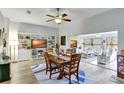 Bright dining room with a wooden table and chairs near built-in shelving at 5025 St Andrews Arc, Leesburg, FL 34748