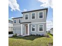 Charming two-story home featuring a two-car garage and lush green lawn at 5714 Cattle Ranch Dr, Saint Cloud, FL 34771