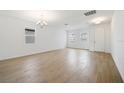 Bright, open living room with wood-style tile floors and modern lighting at 5714 Cattle Ranch Dr, Saint Cloud, FL 34771
