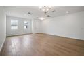 Bright, open living room with wood-style tile floors and modern lighting at 5714 Cattle Ranch Dr, Saint Cloud, FL 34771