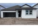 One-story home with gray roof and attached garage at 5723 Cattle Ranch Dr, Saint Cloud, FL 34771
