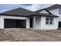 Newly built home with gray roof and attached garage at 5723 Cattle Ranch Dr, Saint Cloud, FL 34771