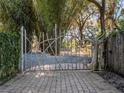 Unique custom gate design adding an artistic touch to the property's entrance at 6320 Rocky Point Rd, Lake Wales, FL 33898