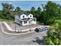 A two-story home with black windows, construction materials and equipment on the property at 1309 Errol Green Ct, Apopka, FL 32712