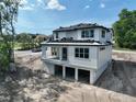 The rear exterior of the two-story house with a porch and open lower level at 1309 Errol Green Ct, Apopka, FL 32712
