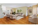 Bright living room featuring wood floors, fireplace, modern furniture, and a large window with natural light at 7200 Grace Rd, Orlando, FL 32819