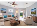 Living room featuring a ceiling fan, neutral color scheme, tile flooring, and sliding glass doors to backyard at 11313 Via Andiamo, Windermere, FL 34786