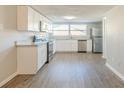 Modern kitchen with white cabinets, granite countertops, and stainless steel appliances at 2220 Menomonee Ct, Orlando, FL 32818