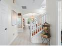 Bright and spacious entryway with staircase and hardwood floors at 555 Carey Way, Orlando, FL 32825