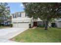 Two-story house with a two-car garage and lush green landscaping at 555 Carey Way, Orlando, FL 32825
