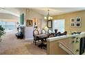 Formal dining room with table, chairs, and view into living room at 6450 Alcalde Ct # 110, Orlando, FL 32835