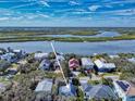 Aerial view of the home with nearby intercoastal waterway, showcasing prime waterfront neighborhood at 6353 River Rd, New Smyrna Beach, FL 32169