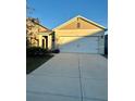 New single-story house with a two-car garage and neutral-colored siding at 791 Chinoy Rd, Davenport, FL 33837