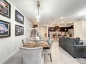 Open-concept dining area flows into the kitchen, featuring modern lighting and neutral decor at 4190 Lana Ave, Davenport, FL 33897