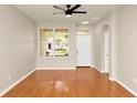 Bright living room boasts hardwood floors, a ceiling fan, and natural light, ideal for gatherings at 14480 Chinese Elm Dr, Orlando, FL 32828