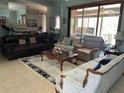 Spacious living room with sofas, a decorative rug, and large windows overlooking the backyard at 2355 Abalone Blvd, Orlando, FL 32833