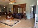 Bright living room with tan tile floors, area rug, and sliding glass doors leading to patio at 2355 Abalone Blvd, Orlando, FL 32833