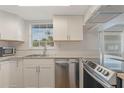 Updated kitchen featuring stainless steel appliances and white cabinets at 1000 S Semoran Blvd # 814, Winter Park, FL 32792