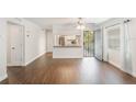 Bright living room with dark laminate wood floors and kitchen pass-through at 1000 S Semoran Blvd # 814, Winter Park, FL 32792